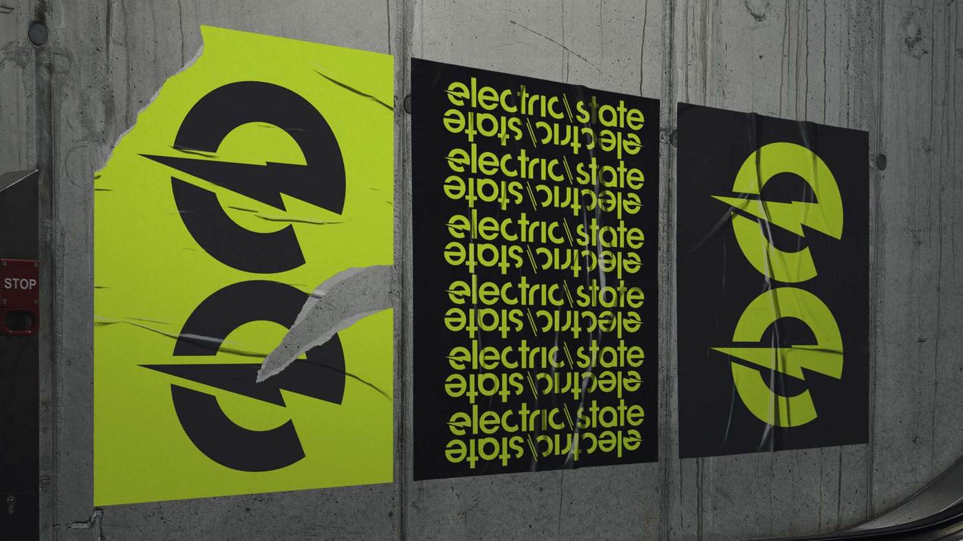 Electric State posters wheat-pasted on a concrete wall